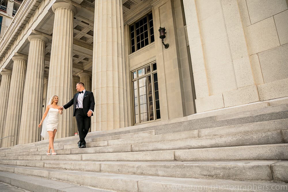 Happy bride and groom celebrating their intimate elopement in Miami, captured with warm natural light and a scenic backdrop.