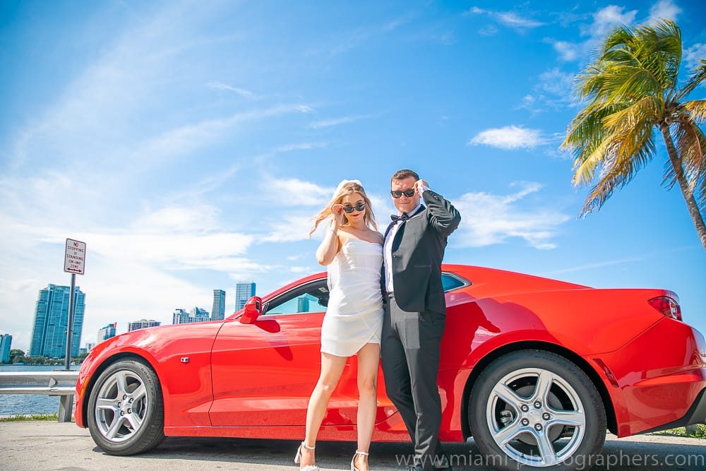 Bride and groom walking hand in hand along the beach during their Miami elopement, professionally photographed.