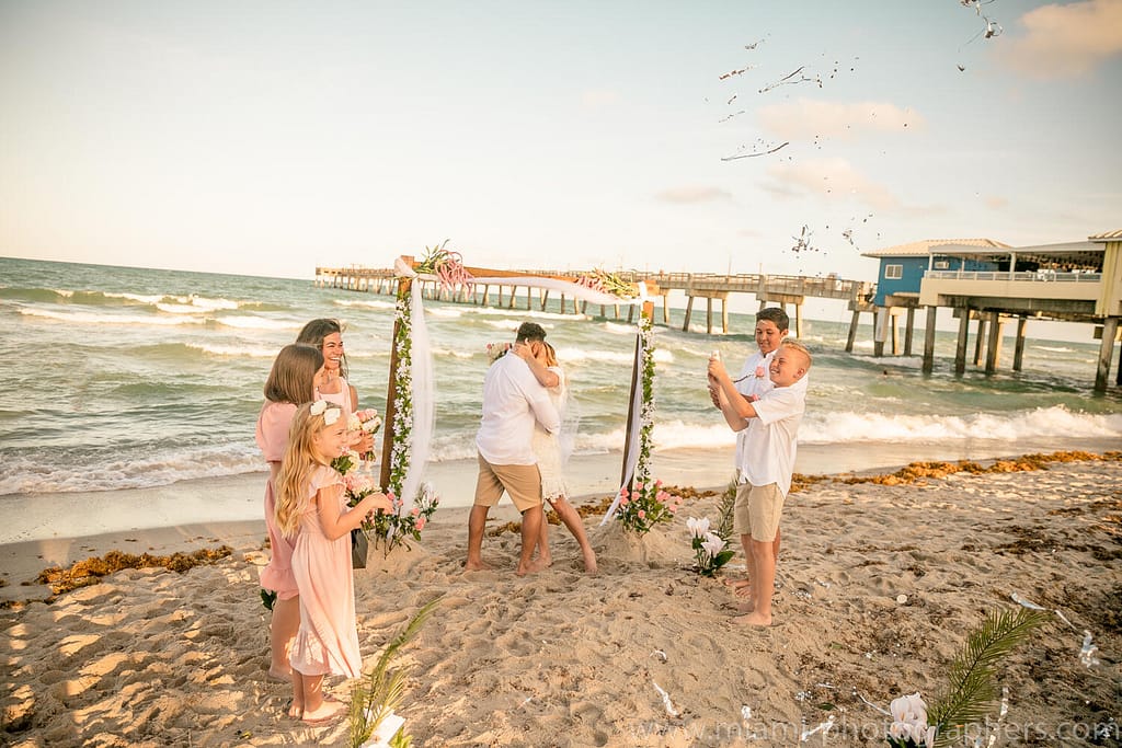 Engagement Photographer Miami 23 Bride walking down the aisle on the sandy Miami beach, captured by a professional wedding photographer