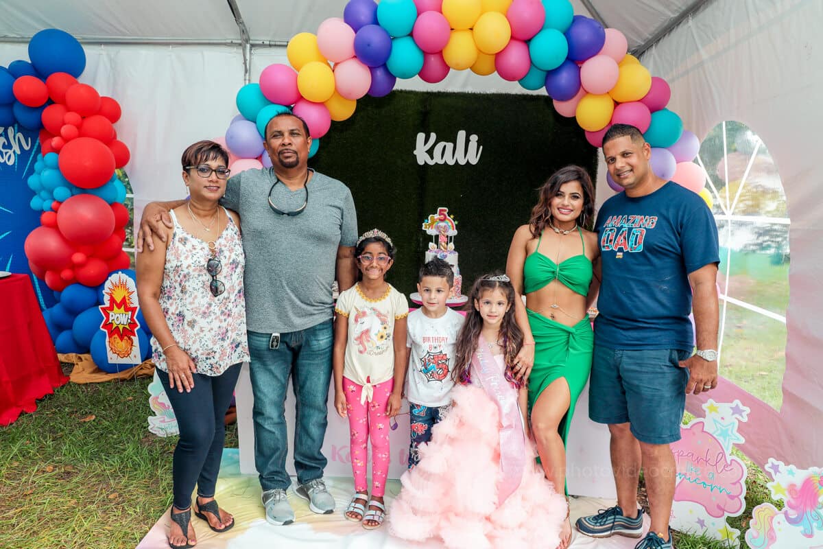 Happy family posing together at a kid’s birthday party in Miami, professionally photographed