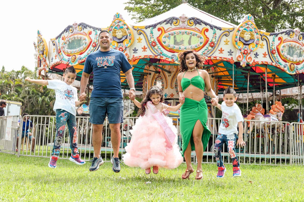 Kids and family smiling at a birthday party, captured by a Miami photographer