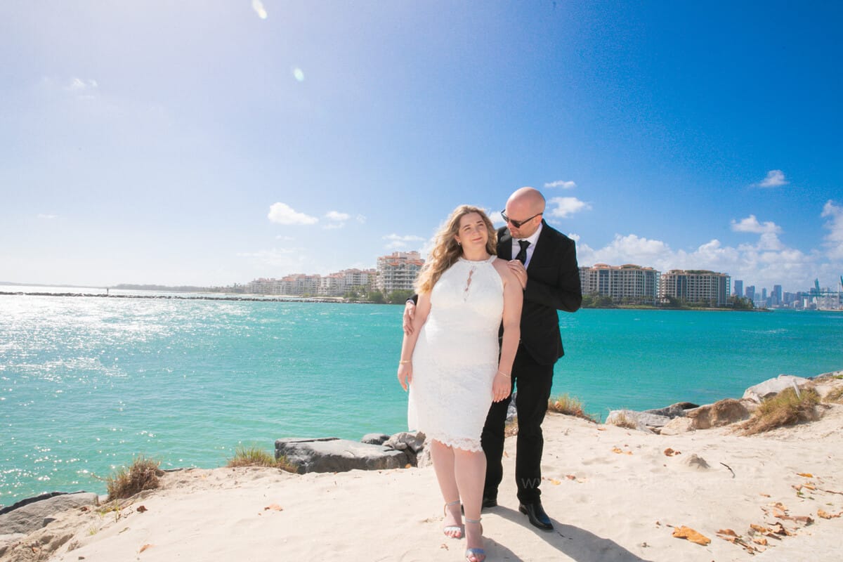 Happy couple celebrating their beach elopement in Miami, captured by a professional wedding photographer