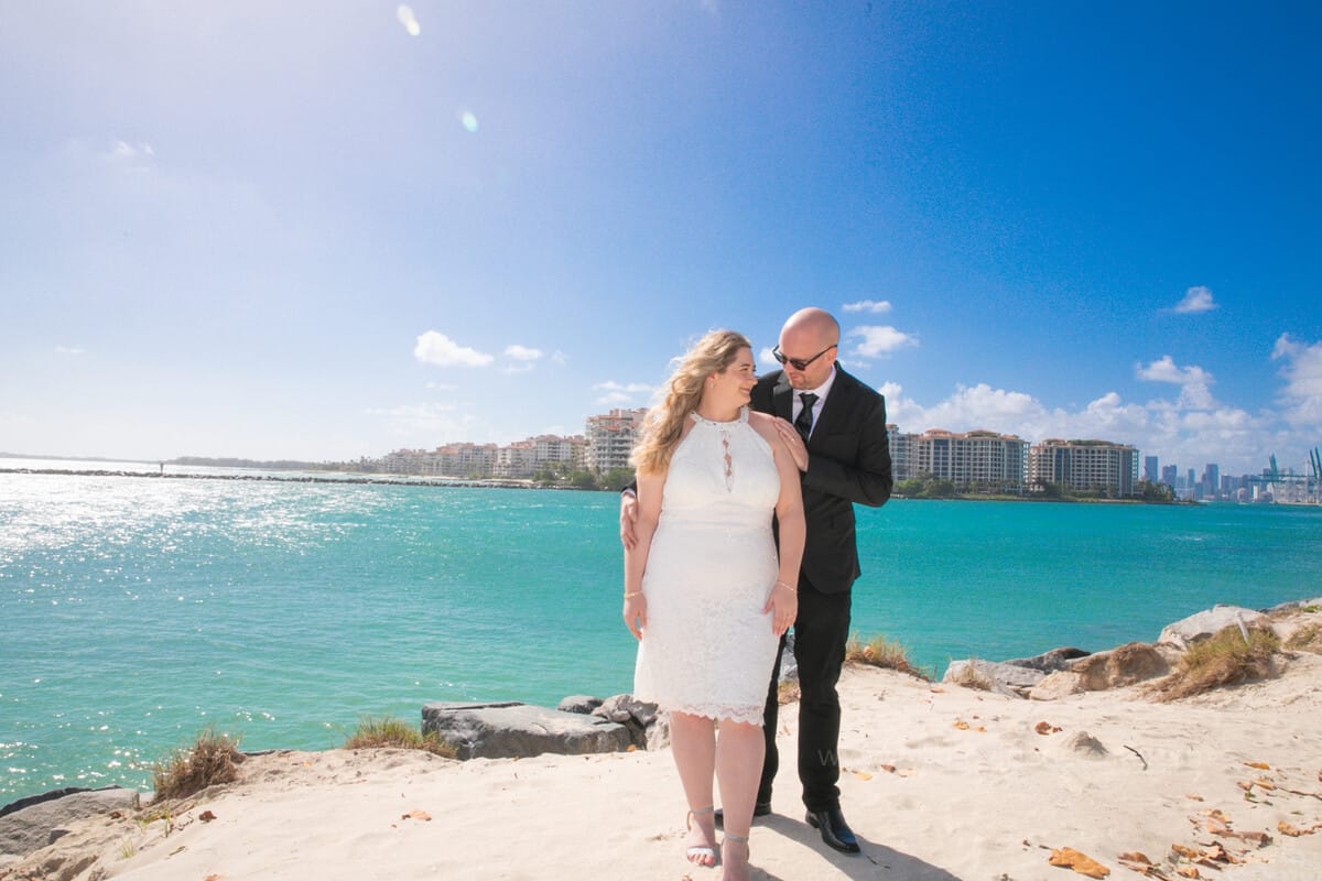 Couple laughing together outside Miami Beach City Hall during their courthouse wedding photoshoot