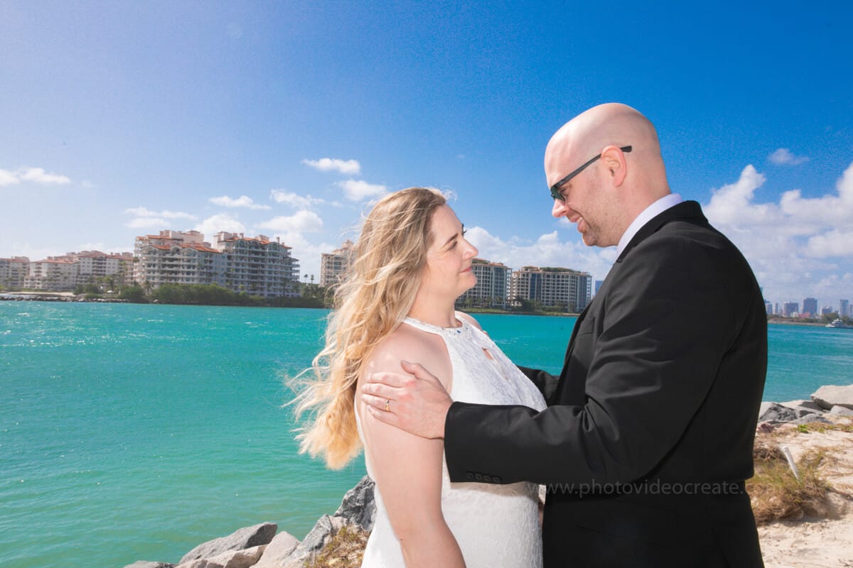 Bride and groom embracing outside Miami Beach City Hall during their intimate courthouse wedding, photographed by a Miami photographer