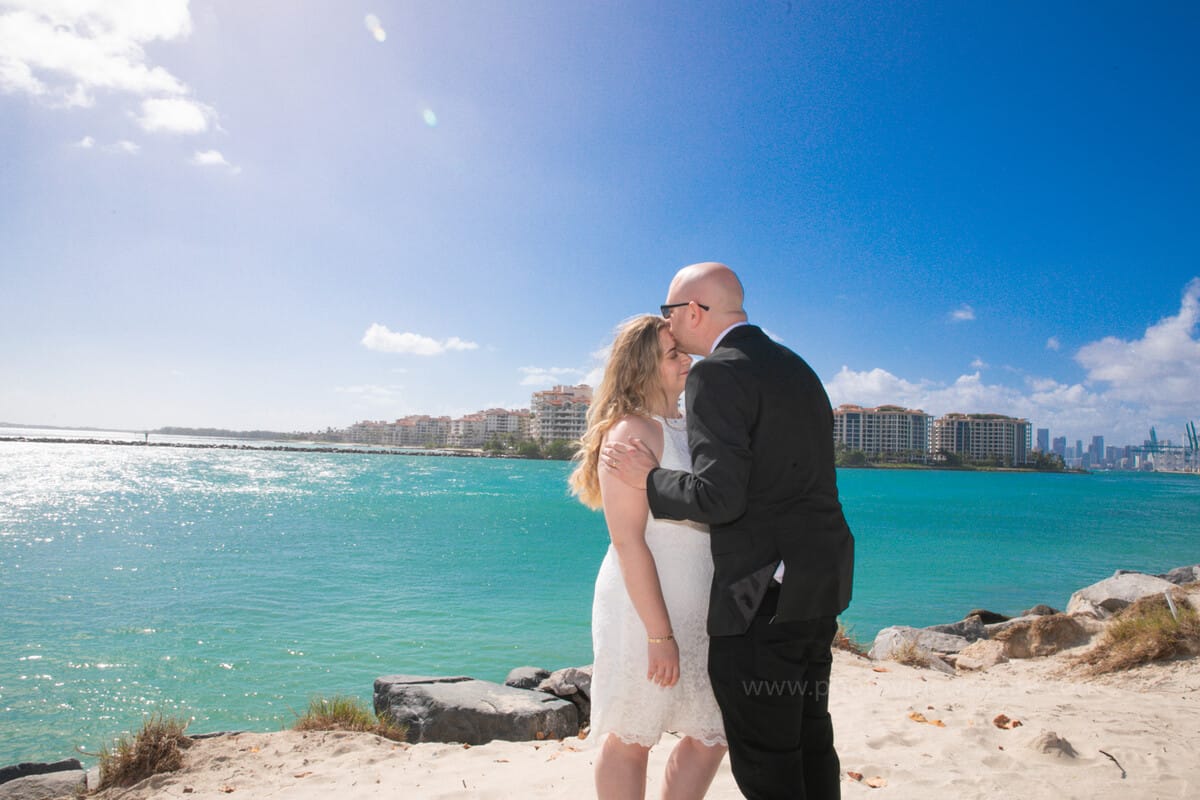 Newlyweds posing in front of Miami Beach City Hall after their courthouse wedding, photographed by a professional Miami photographer