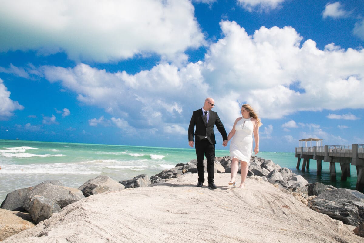 Bride and groom walking outside Miami Beach City Hall after their courthouse wedding, captured by a Miami photographer