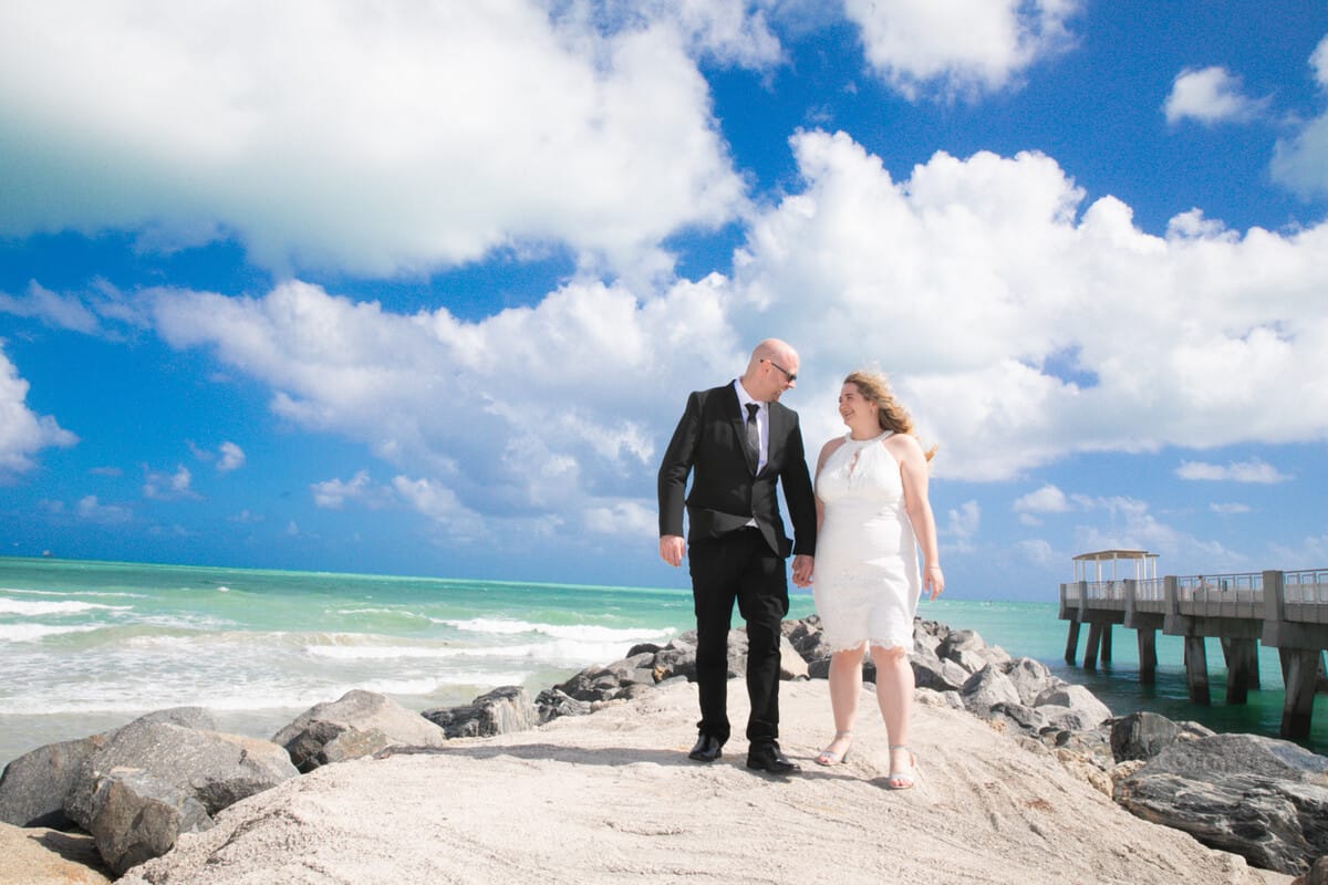 Bride and groom posing at Miami City Hall after their wedding in Miami Beach, captured by a professional photographer
