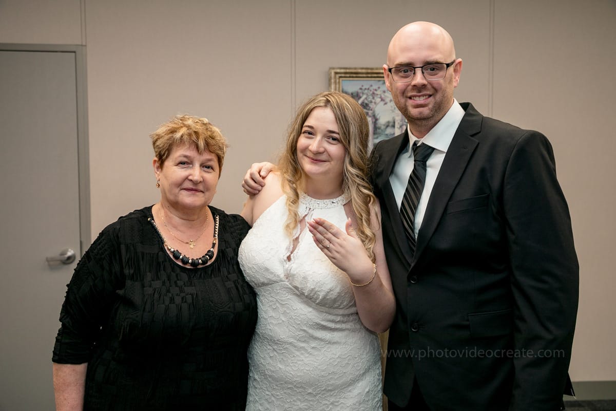 Couple smiling outside Miami Beach City Hall after their classic courthouse wedding, captured by a professional photographer