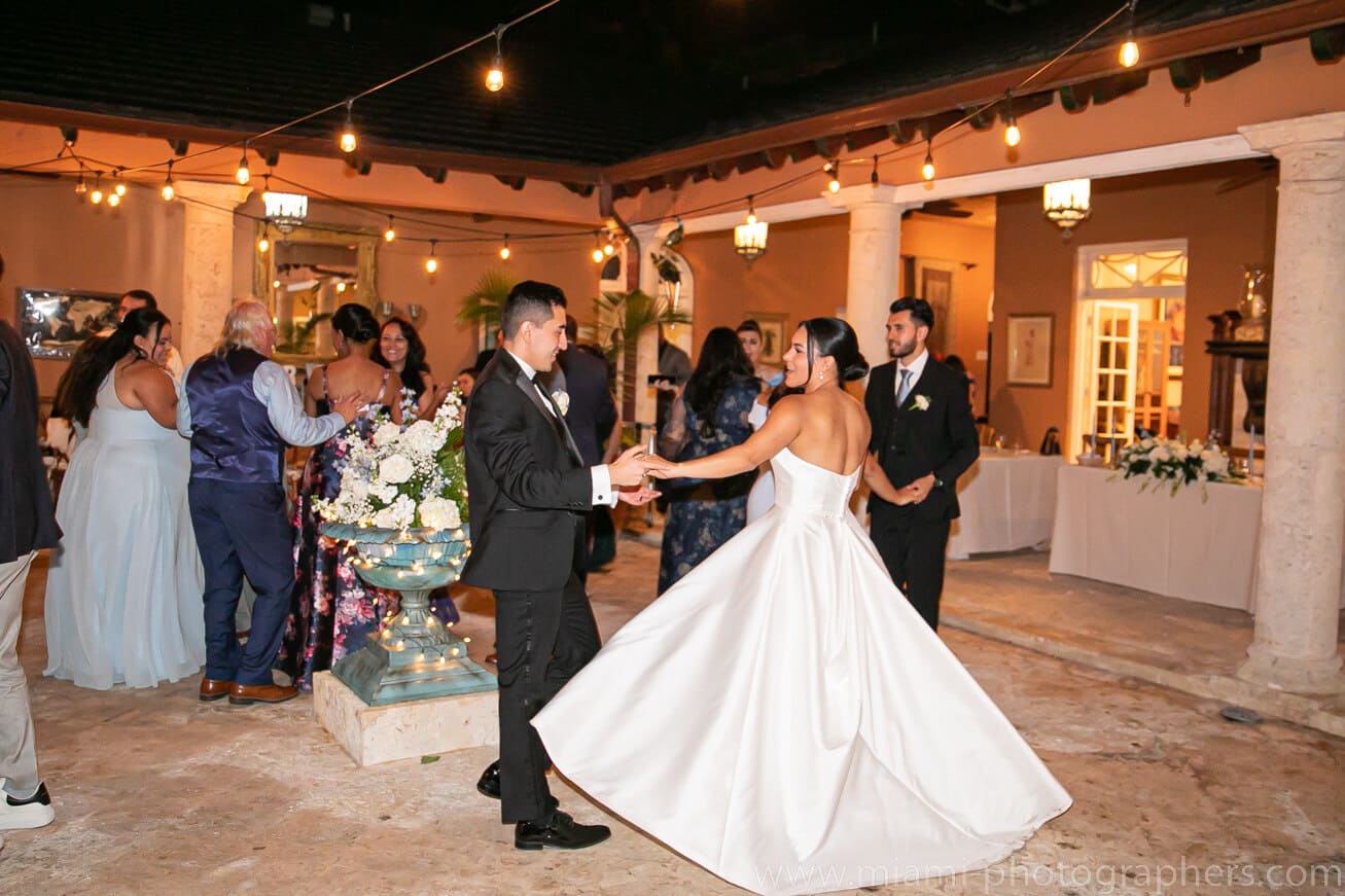 Bride and groom, Roxana and Andres, sharing a candid moment during their Miami wedding, captured with elegant style and natural light.