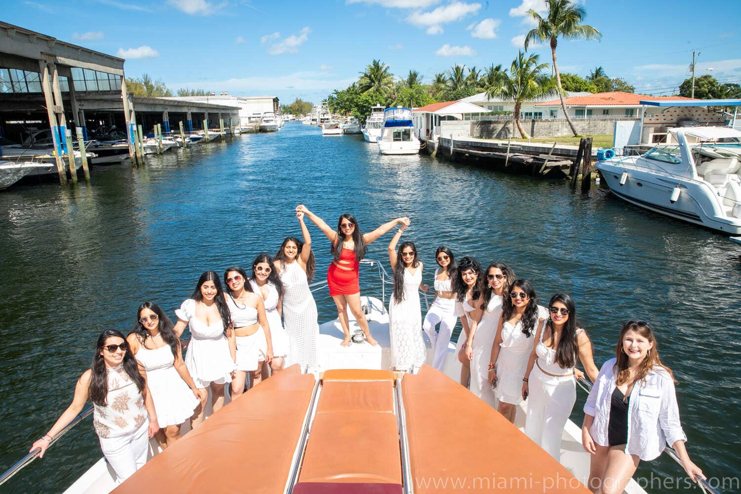 Bride-to-be and her friends posing for a fun group photo during their bachelorette party on a yacht in Miami, captured by a professional photographer