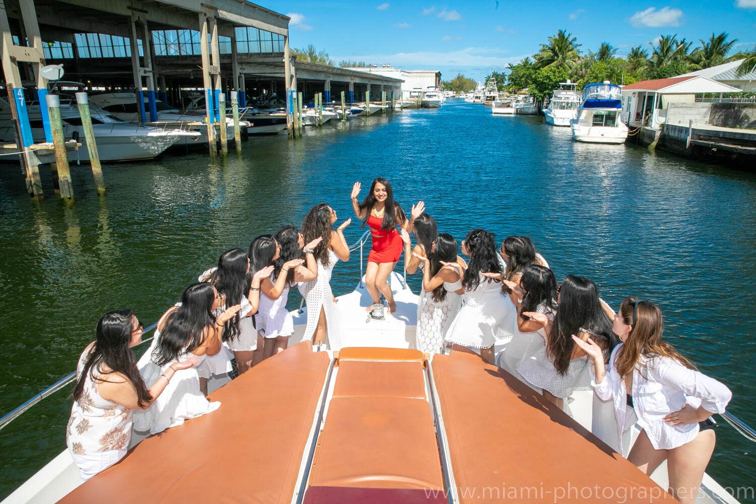 Bride-to-be smiling and enjoying quality time with friends during a bachelorette party on a yacht in Miami, captured by a professional photographer