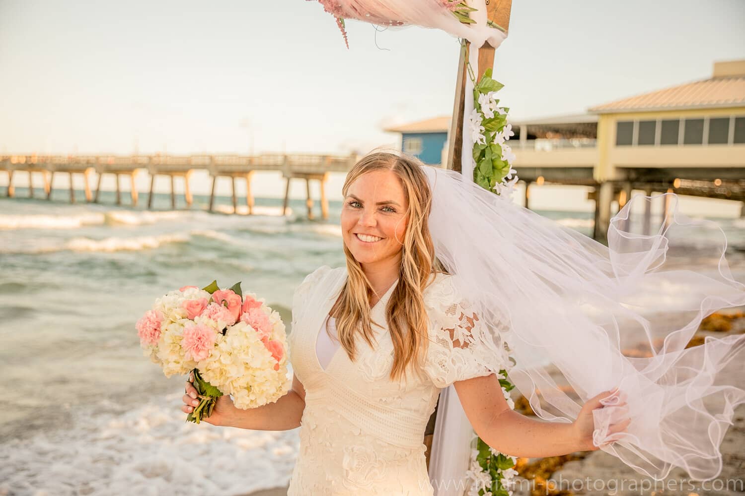 Bride and groom sharing a loving moment at sunset during their intimate Miami beach wedding, with warm golden light and ocean backdrop.