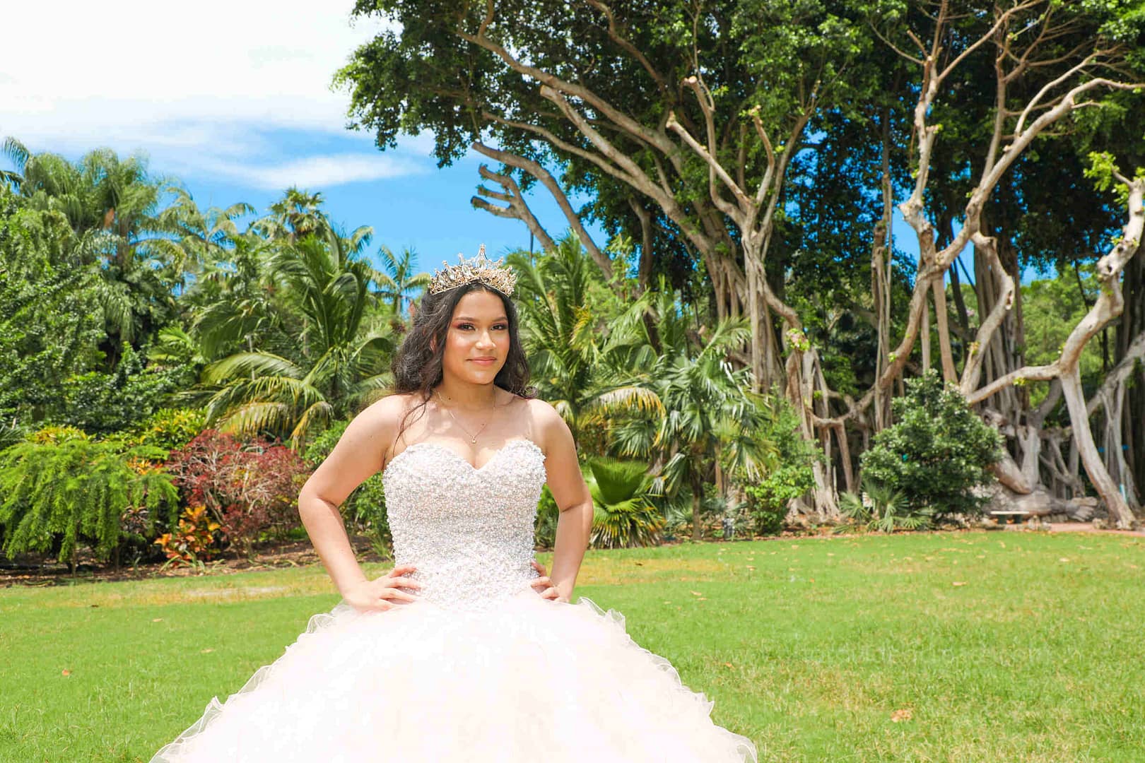 Elegant young woman during her Quinceañera celebration at Pinecrest Gardens in Miami, professionally photographed