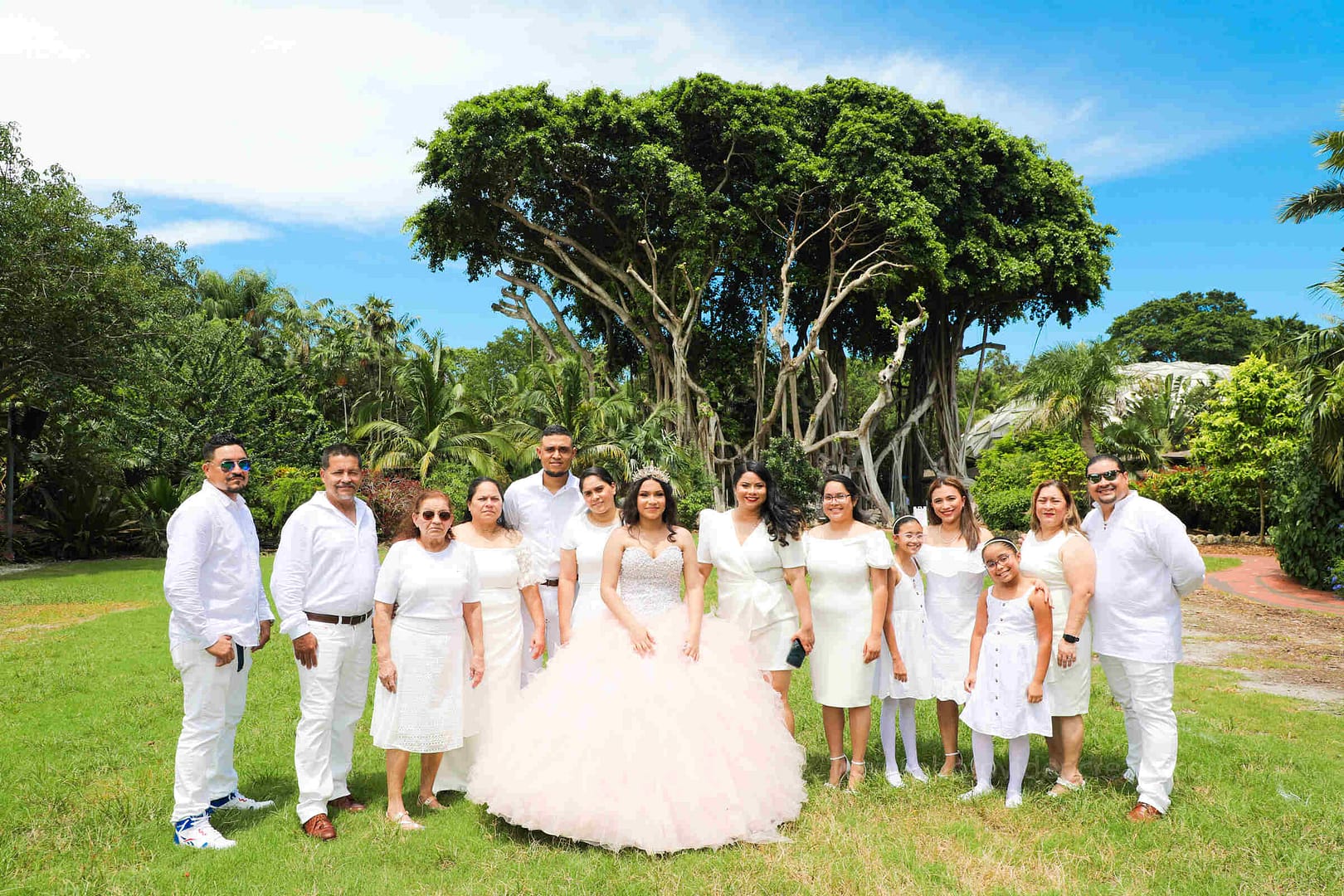 Joyful young woman celebrating her Quinceañera at Pinecrest Gardens in Miami, professionally photographed