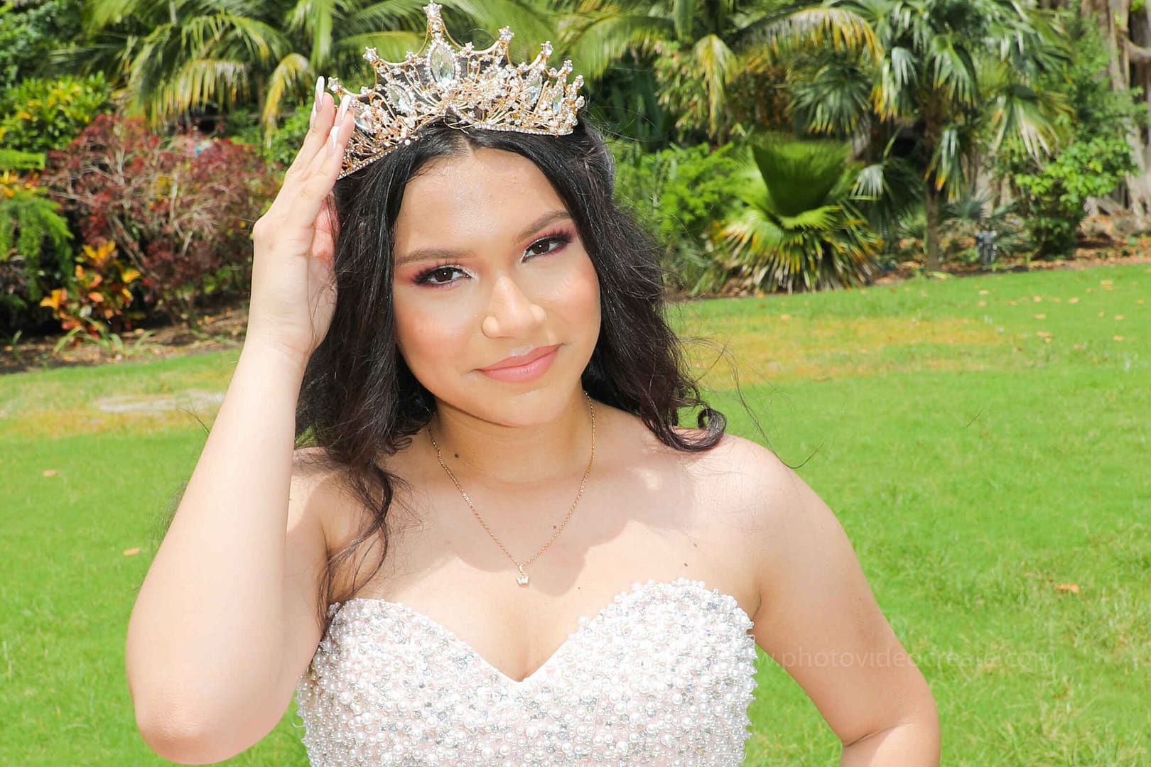 Memorable moment of a young woman celebrating her Quinceañera at Pinecrest Gardens in Miami, professionally photographed