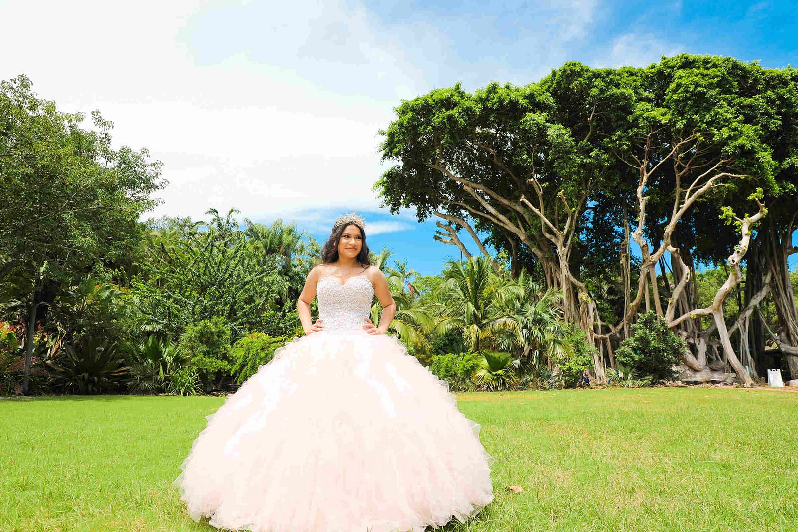Elegant young woman during her Quinceañera celebration at Pinecrest Gardens in Miami, professionally photographed