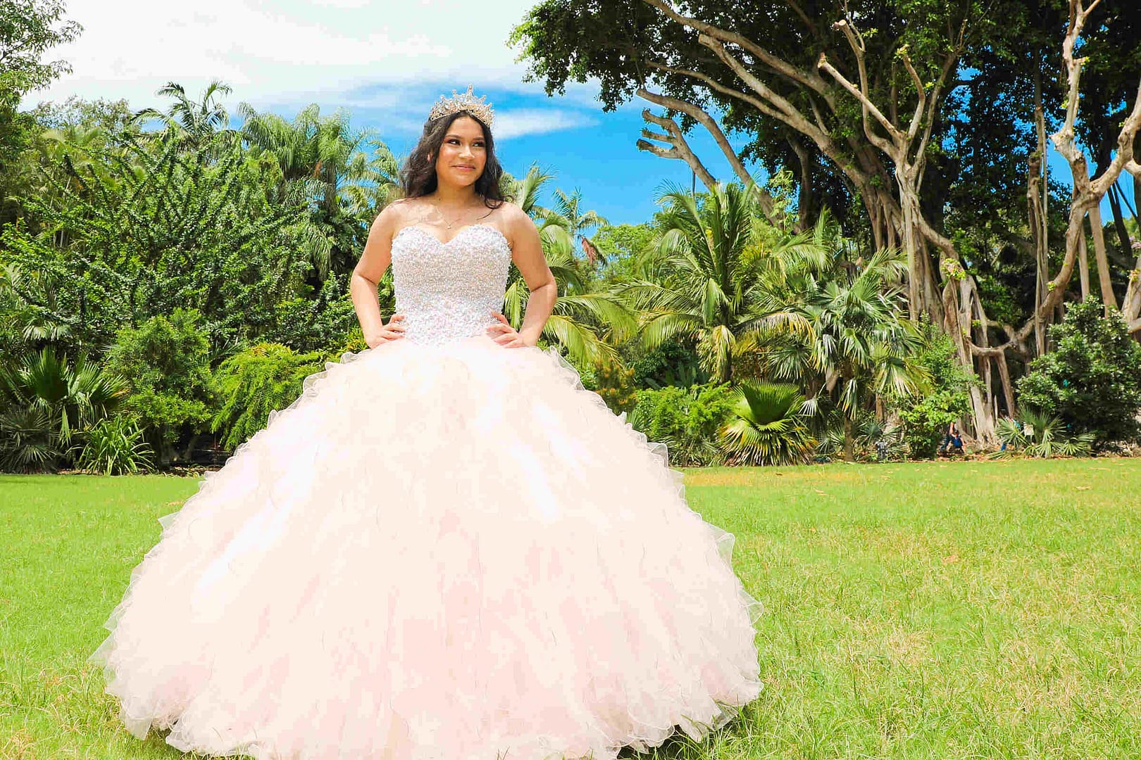 Memorable moment of a young woman celebrating her Quinceañera at Pinecrest Gardens in Miami, professionally photographed