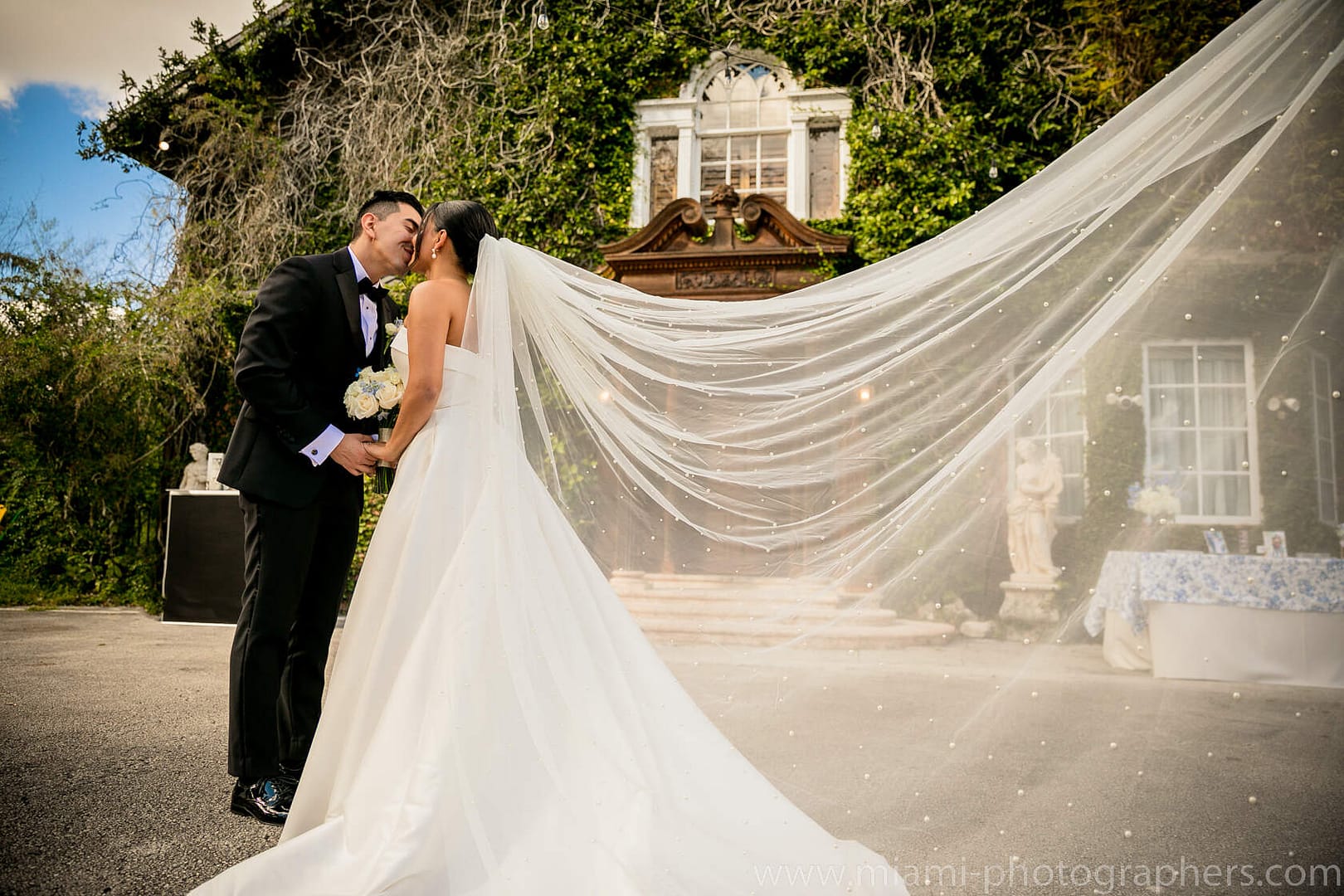 Bride and groom Roxana and Andres sharing a tender embrace during their romantic Miami wedding, captured with soft natural light and elegant surroundings.