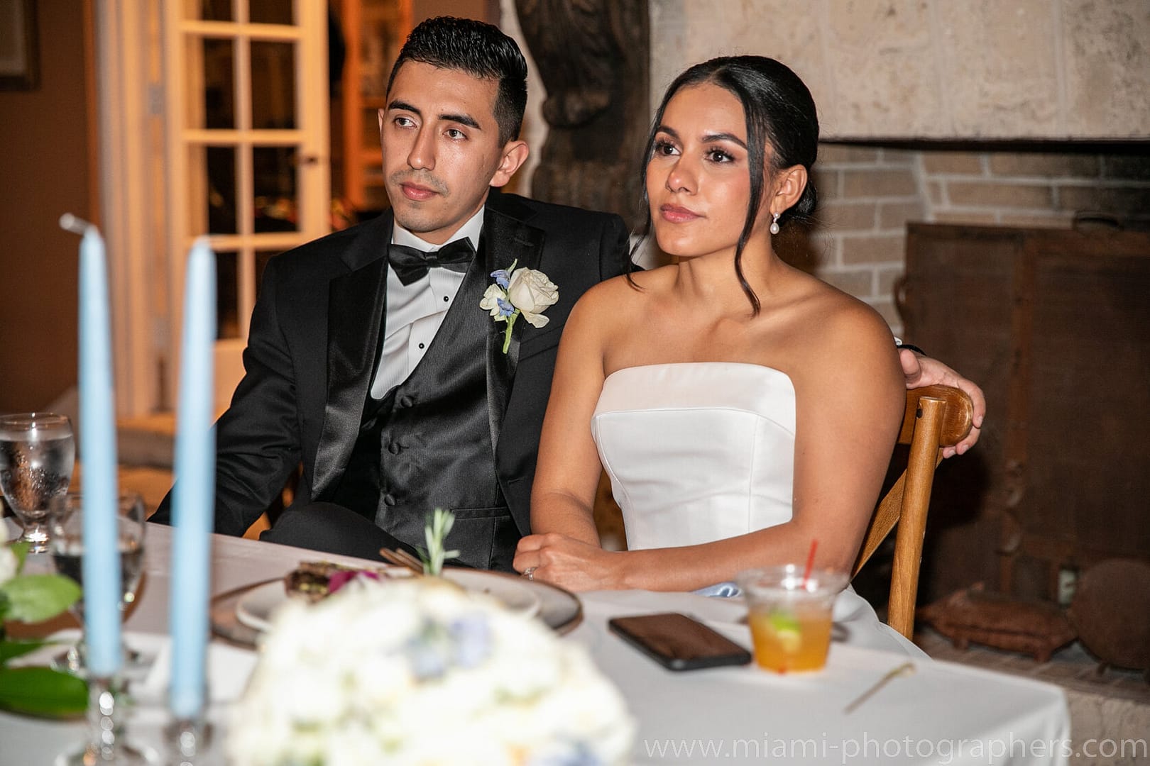 Roxana and Andres walking hand in hand during their Miami wedding, captured in a romantic moment filled with joy, elegance, and soft natural light.