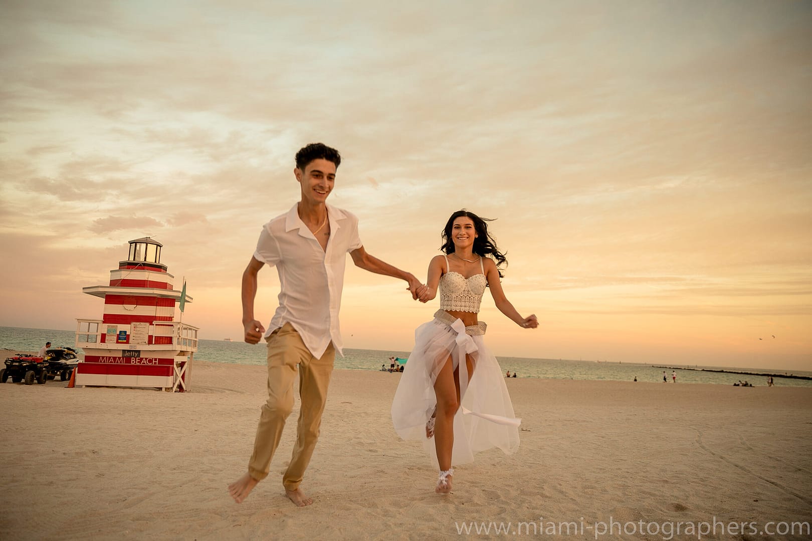 Romantic couple captured during a sunset honeymoon photoshoot on Miami Beach, professionally photographed.