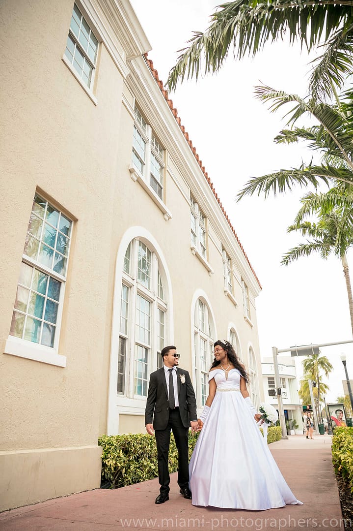 Joyful Jewish bride and groom celebrating their wedding ceremony under the chuppah in Miami.