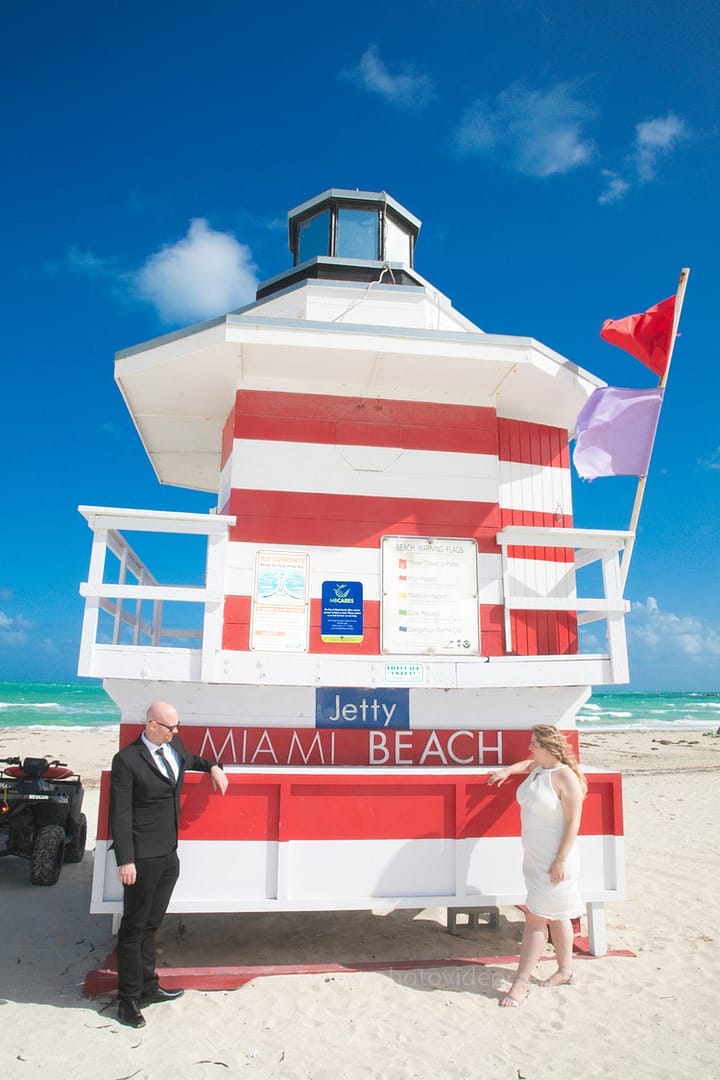 Bride smiling brightly outside Miami Beach City Hall, captured by a Miami wedding photographer