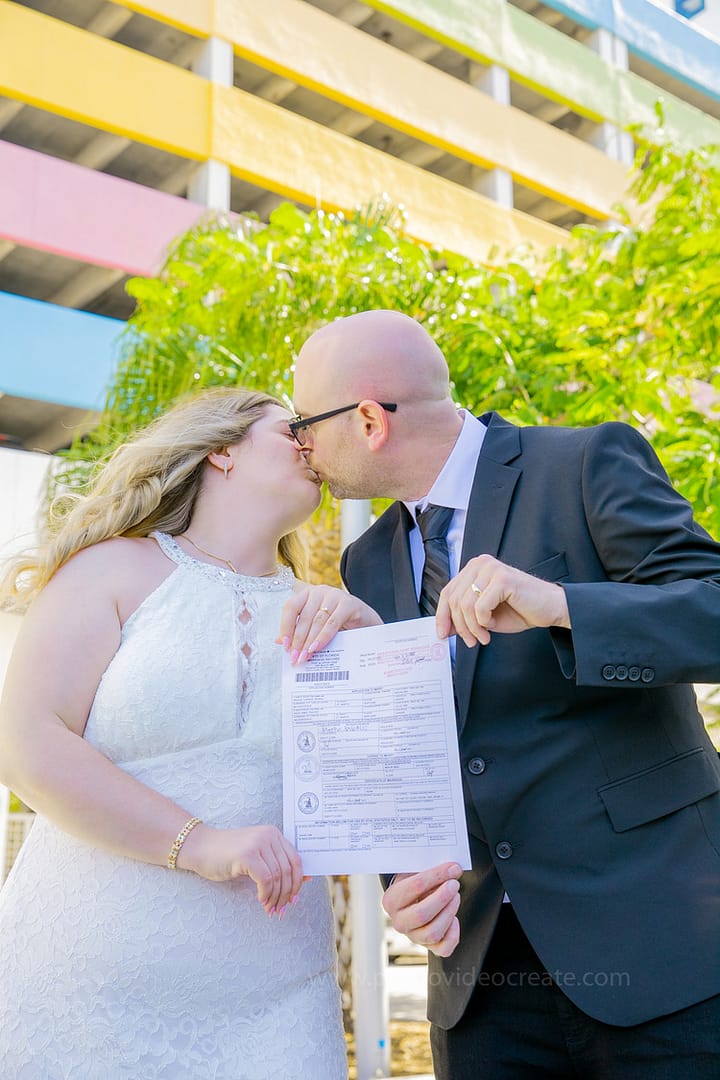 Newlywed couple celebrating happily outside Miami Beach City Hall, photographed by a Miami wedding photographer