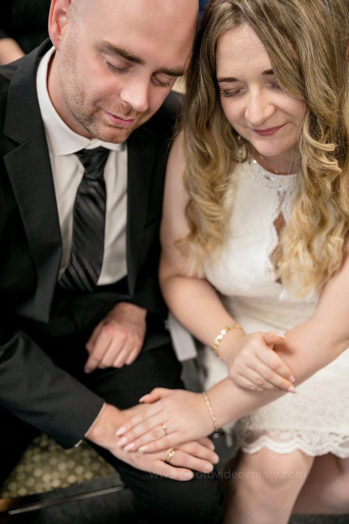 Newlywed couple celebrating joyfully in front of Miami Beach City Hall, captured by a professional Miami photographer