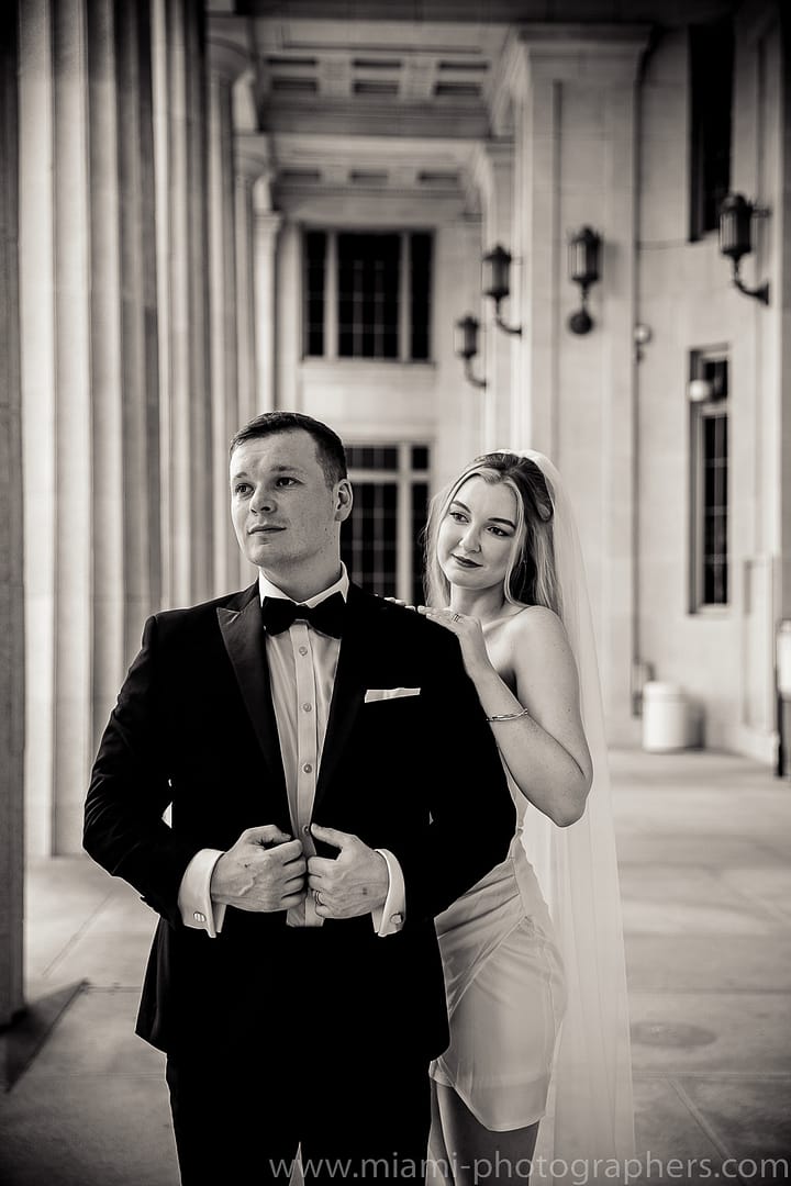 Bride and groom sharing a tender moment during their intimate Miami elopement, with soft natural lighting and a beautiful outdoor setting.