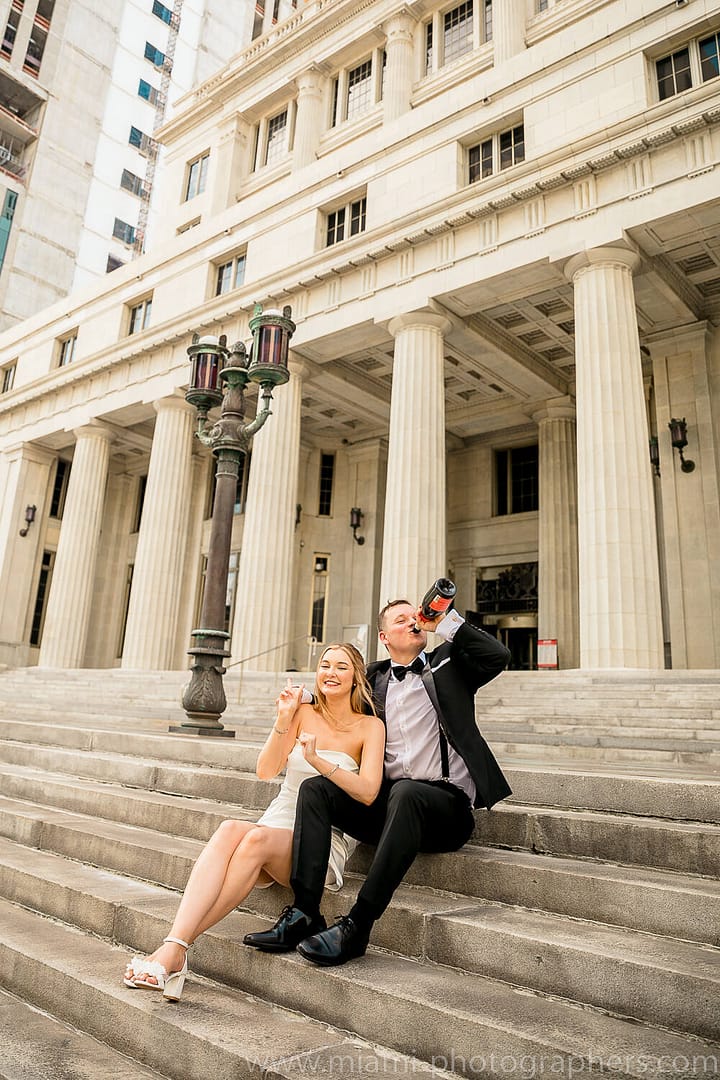 Bride and groom sharing a romantic moment during their chic elopement in Miami, surrounded by lush greenery and soft natural light.
