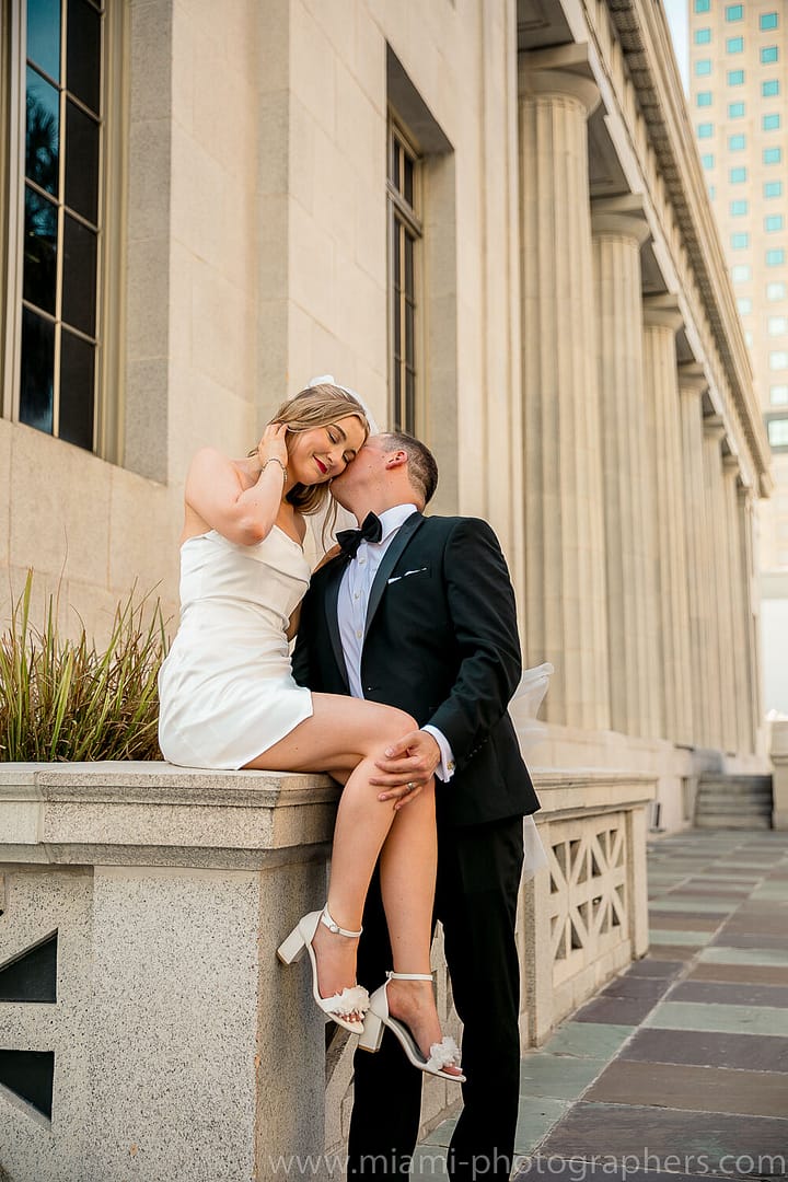 Bride and groom posing elegantly during their intimate wedding elopement in Miami, with soft natural lighting and a classic backdrop.