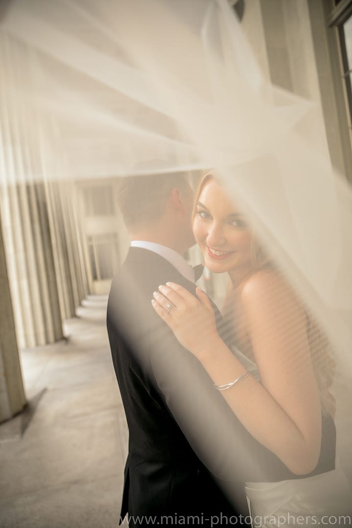 Candid moment of a couple laughing together during their Miami beach elopement, with natural light and ocean breeze adding to the romantic vibe.