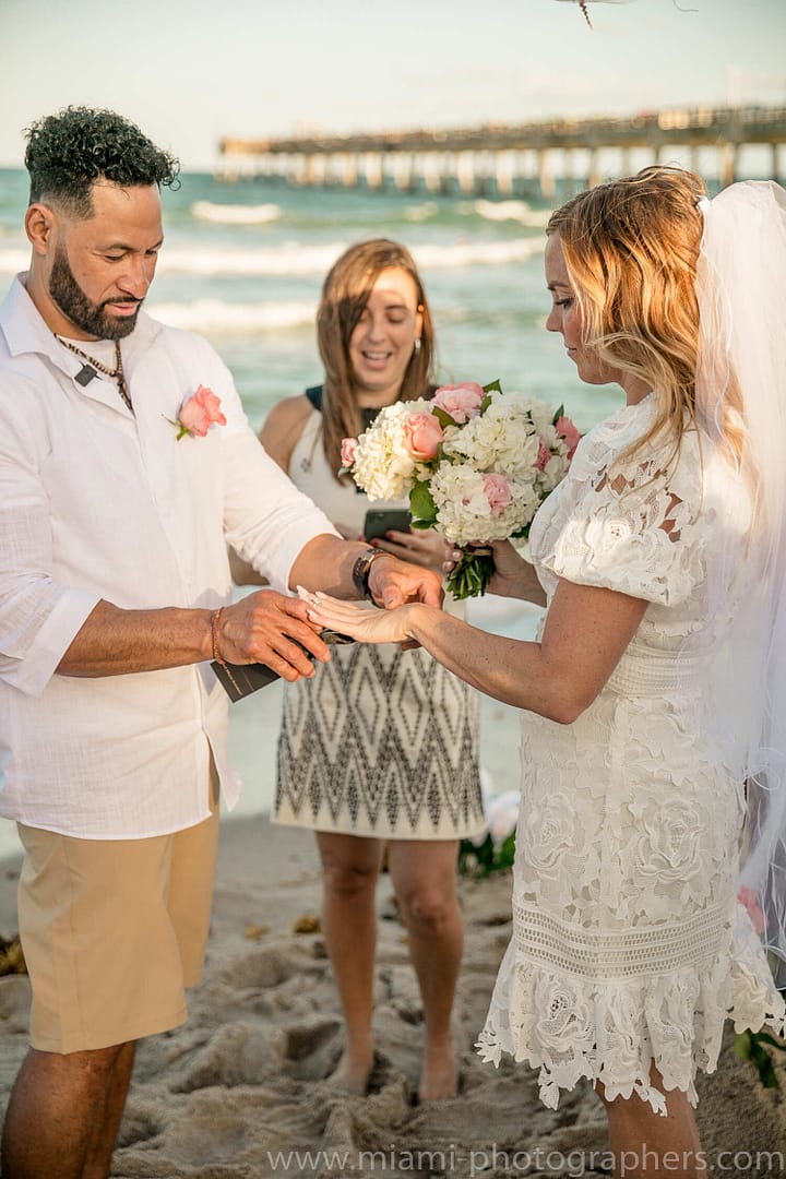 Bride and groom sharing a quiet moment by the ocean during their intimate Miami beach wedding, with soft light and a peaceful shoreline view.
