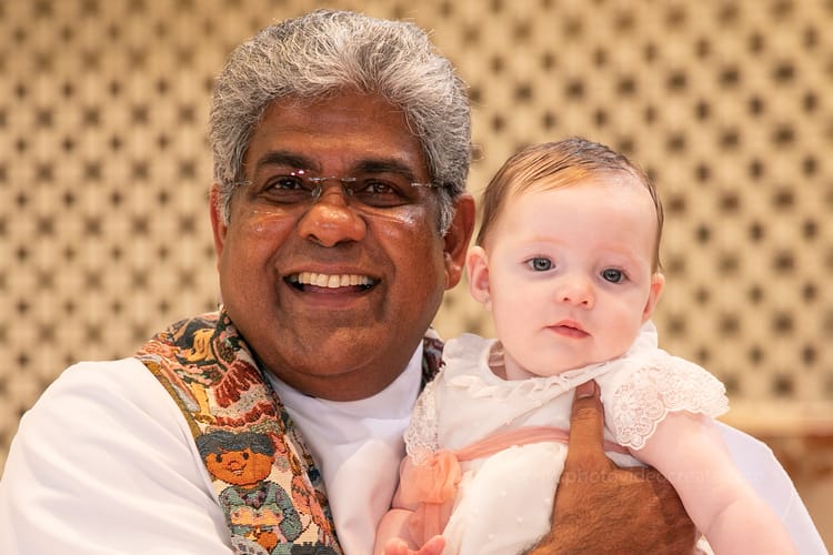 Touching baptism moment at St. Rose of Lima Church in Miami captured by a professional photographer