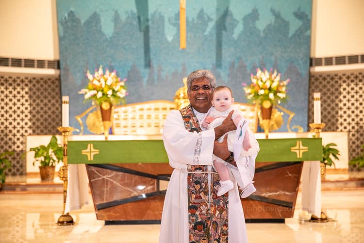 Beautiful baptism moment at St. Rose of Lima Church in Miami captured by a professional photographer