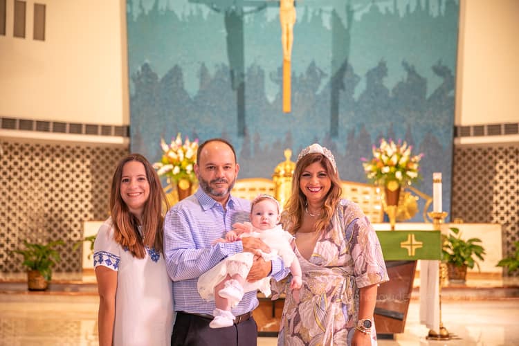 Candid baptism photo at St. Rose of Lima Church in Miami by a professional photographer