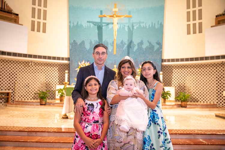 Candid moment during baptism at St. Rose of Lima Church in Miami, photographed by a local professional