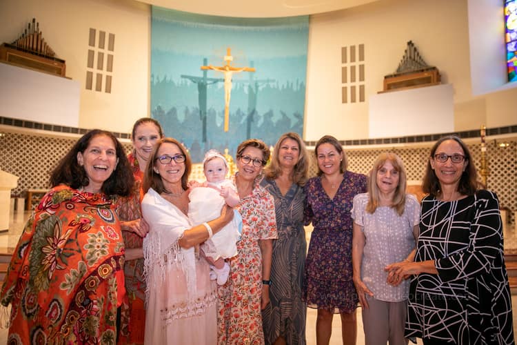 Photographer capturing baptism ceremony highlights at St. Rose of Lima Church, Miami