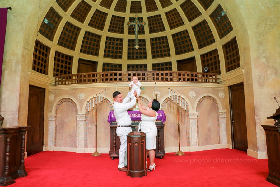 Family gathered for a baptism at Coral Gables United Church of Christ, photographed by a Miami photographer during a heartfelt moment.