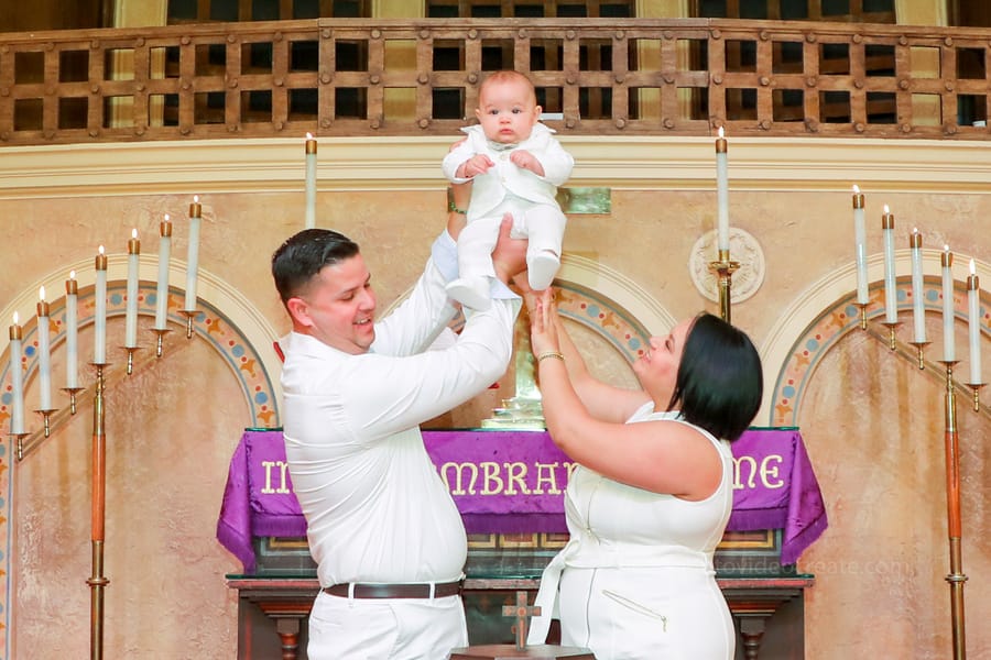 Candid moment during a baptism at Coral Gables United Church of Christ, photographed by a Miami-based professional photographer.