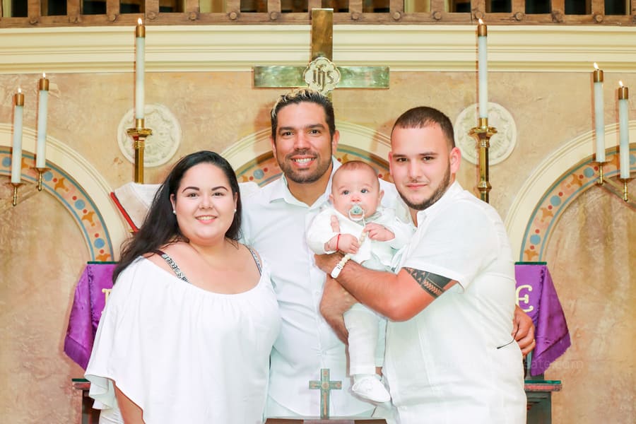A baby being baptized at Coral Gables United Church of Christ, captured by a professional Miami photographer during a special family ceremony.