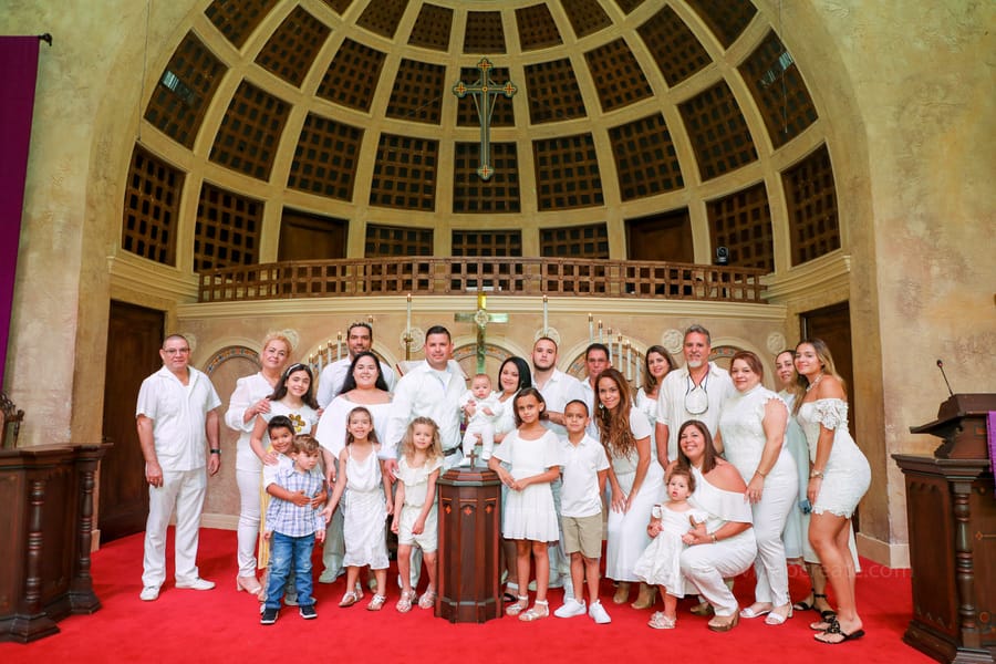 Candid photo of family and guests interacting during baptism ceremony at Coral Gables United Church of Christ in Miami