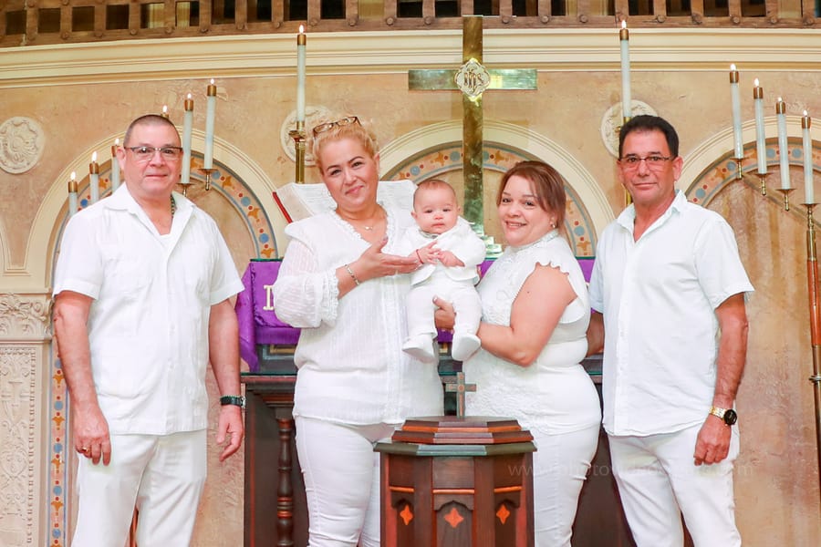 Candid moment of family interacting during baptism at Coral Gables United Church of Christ in Miami