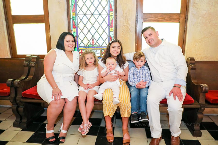 Smiling family posing together after baptism ceremony at Coral Gables United Church of Christ in Miami