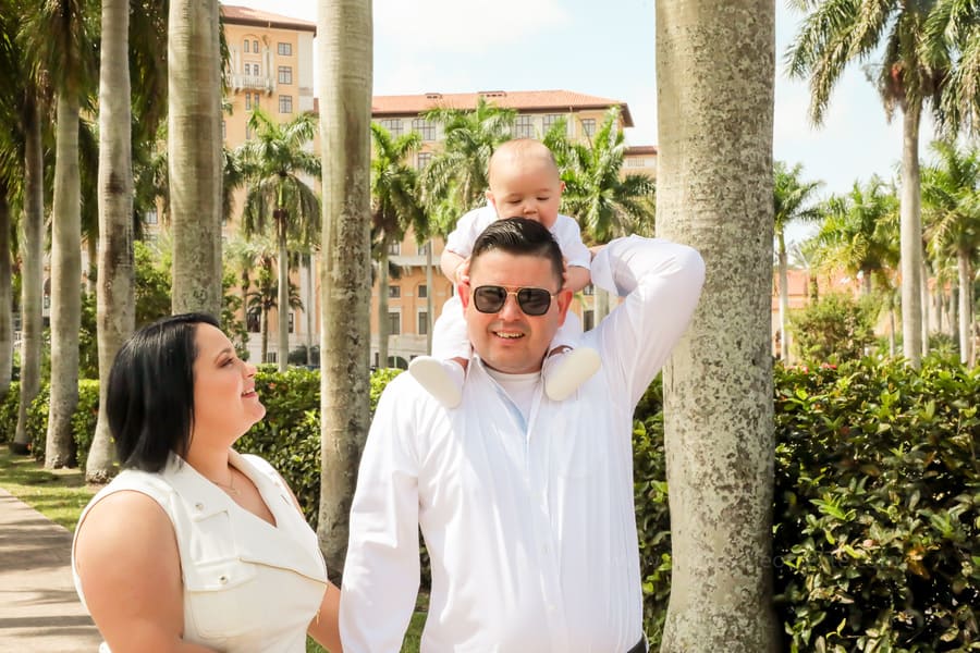Close-up of baby in white baptism outfit at Coral Gables United Church of Christ in Miami